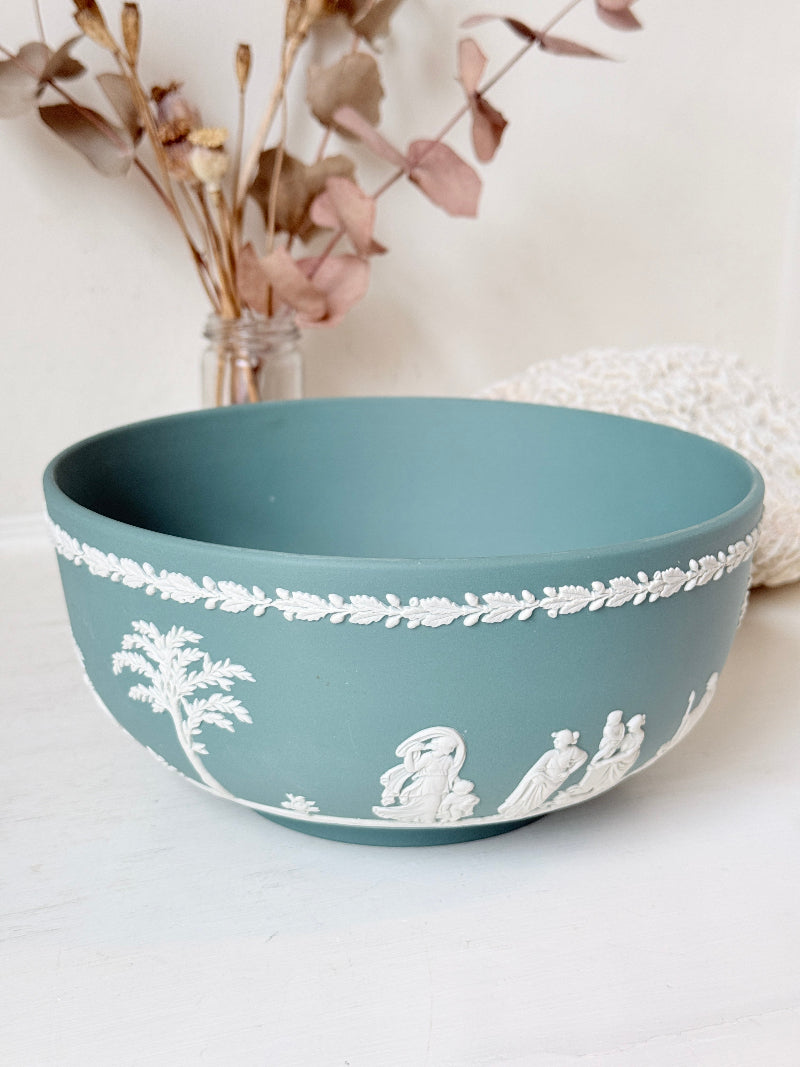 Large vintage Wedgwood Jasperware teal green fruit bowl decorated with white classical figures beneath stylised trees and a laurel garland border.