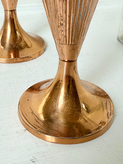 Pair of vintage copper Art Deco vases with fluted surface, photographed on a white background.