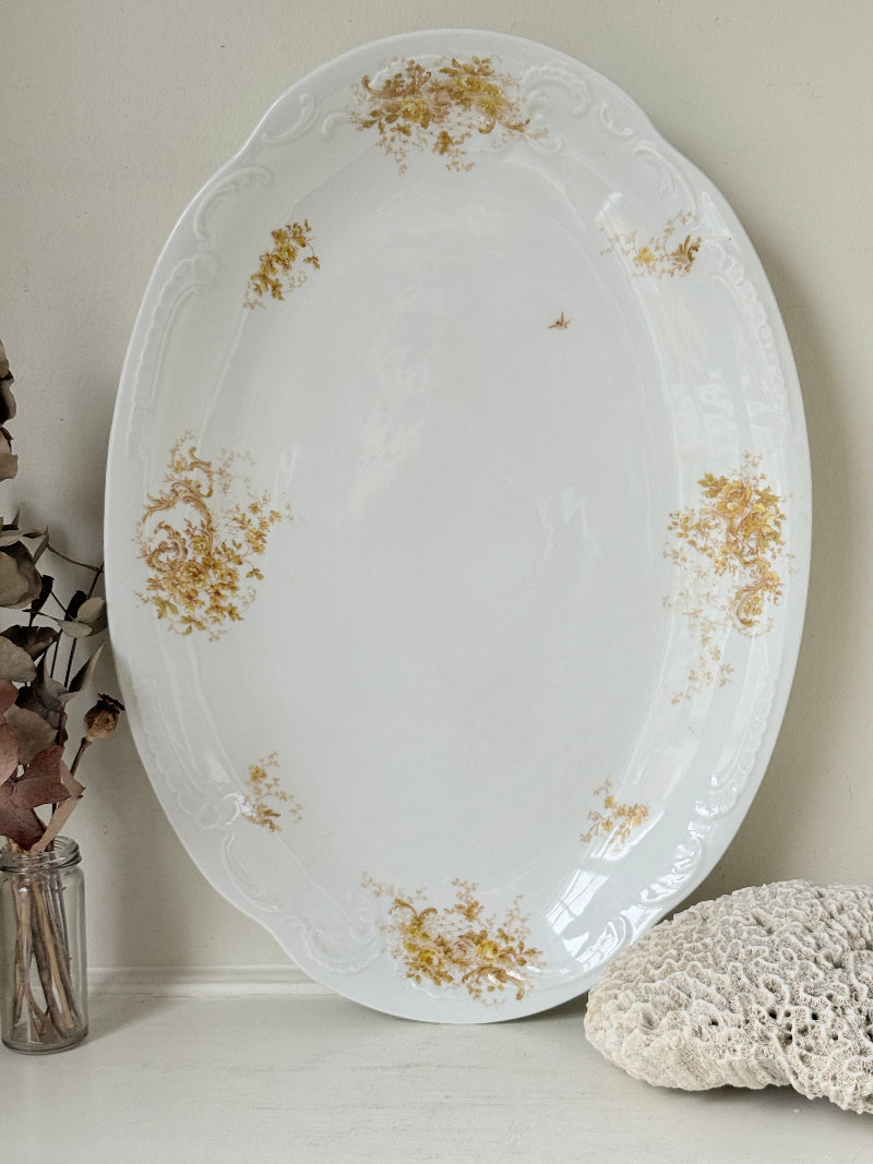 Antique Springer and Co Elbogen Senta porcelain platter in white with floral detail, photographed on a white surface