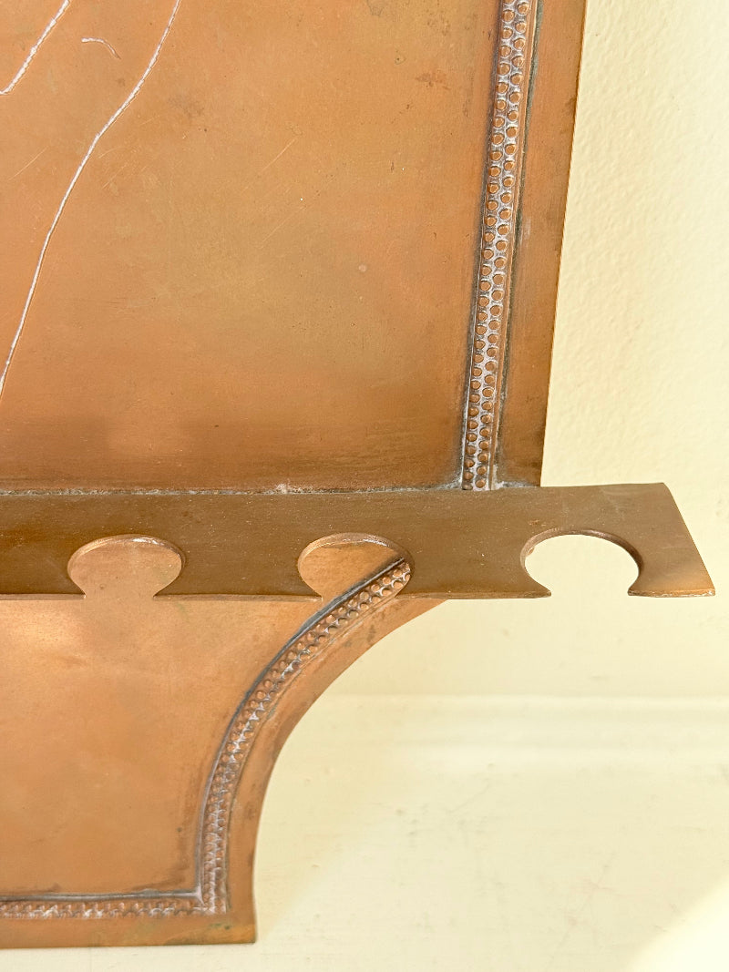 Vintage hanging copper pipe stand with hand etched design, ideal for holding utensils, tools or dog leads, photographed on a white surface beside dried stems.
