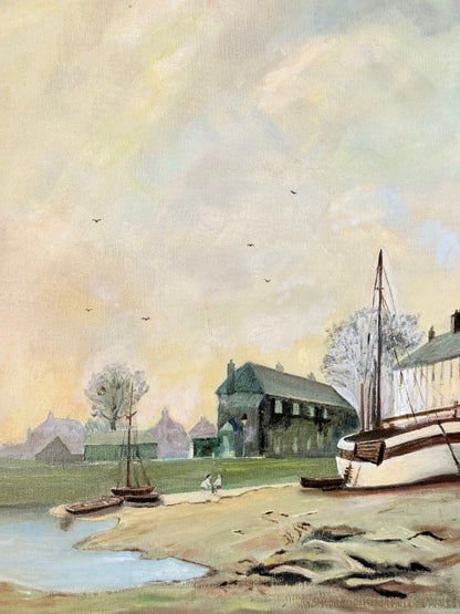 Vintage oil painting on board of a rural village scene with houses, trees, and water, photographed on a white surface