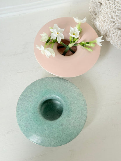 Pair of Poole Pottery mushroom posy vases in seafoam green and blush pink glazes photographed on a white surface