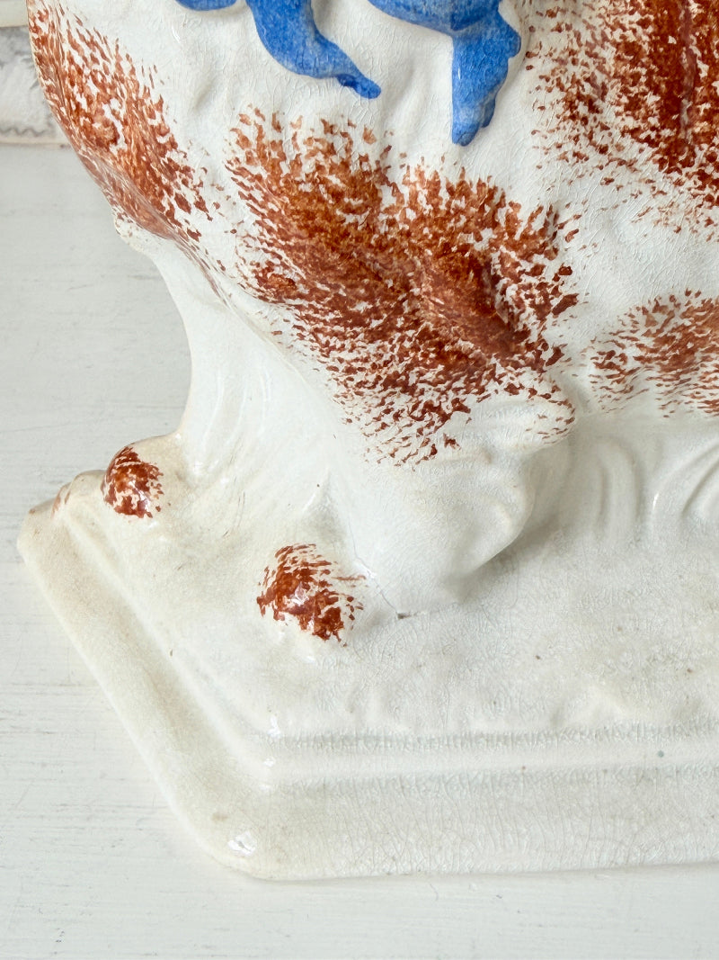 Pair of antique standing Staffordshire Pekingese dogs in rust red and white with blue painted bows