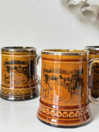 Set of 4 Ridgways stoneware tankard mugs photographed on a white surface in amber brown glaze with black Coaching Days and Coaching Ways transfer scenes