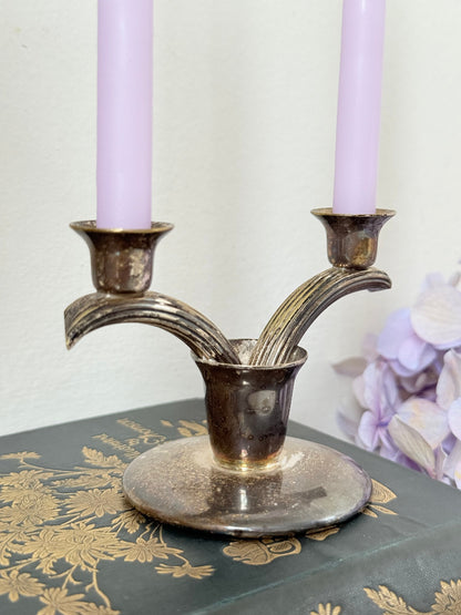 Vintage miniature silver plate candlestick with twin holders, photographed on white surface