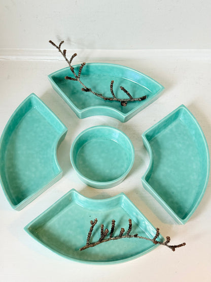 Poole Pottery turquoise hors d’oeuvre dishes set of five displayed on a white surface.