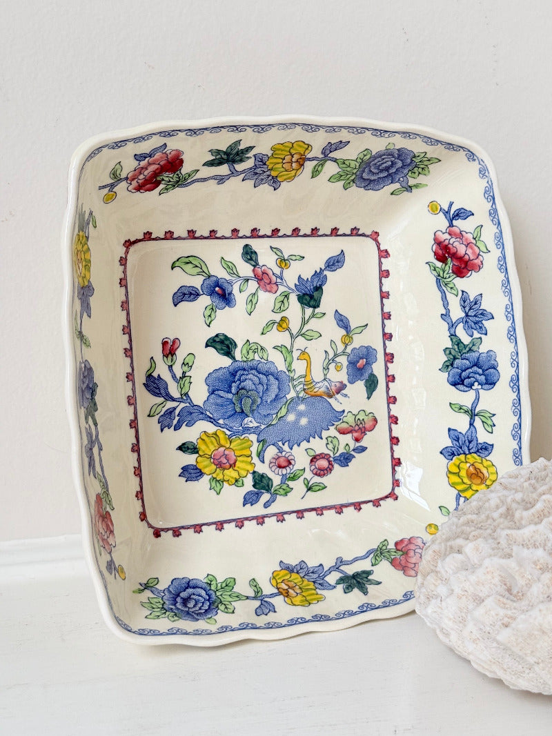 Vintage Mason’s ironstone serving dish with square form and spring floral pattern in blue, pink, yellow, and green, photographed on a white surface