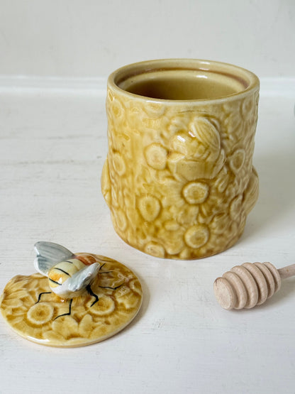 Secla pottery honey jar with lid, bee motif, and wooden honey spoon, made in Portugal, photographed on a white surface