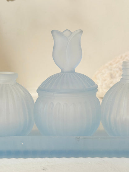 Vintage powder blue frosted glass dresser set with tray and three matching pieces, photographed on a white surface