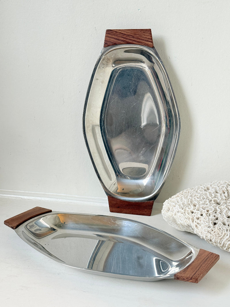 Pair of mid century stainless steel and teak crudites dishes photographed on a white surface