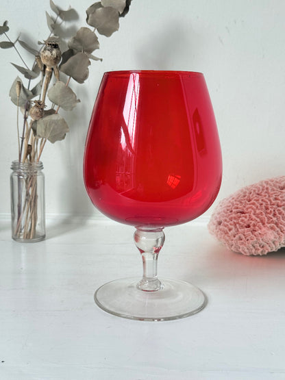 Large retro red glass brandy glass displayed on a white background.
