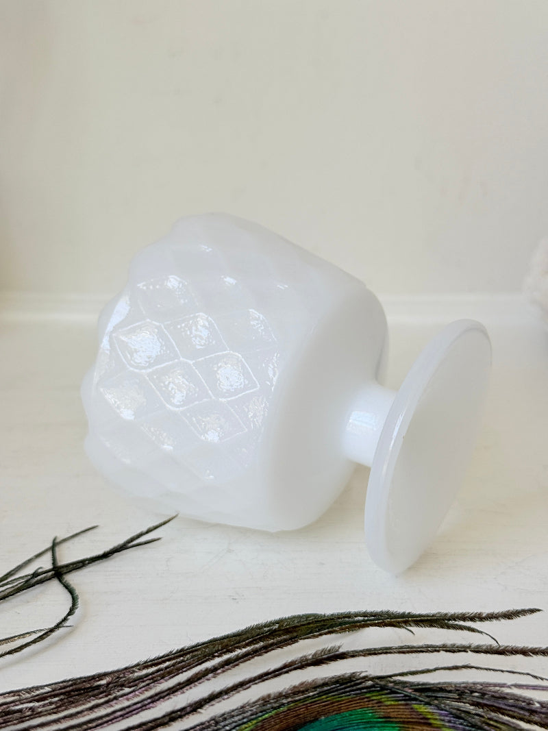 Vintage milk glass footed bowl with scalloped rim and pressed pattern, photographed on a white surface