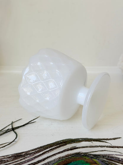Vintage milk glass footed bowl with scalloped rim and pressed pattern, photographed on a white surface