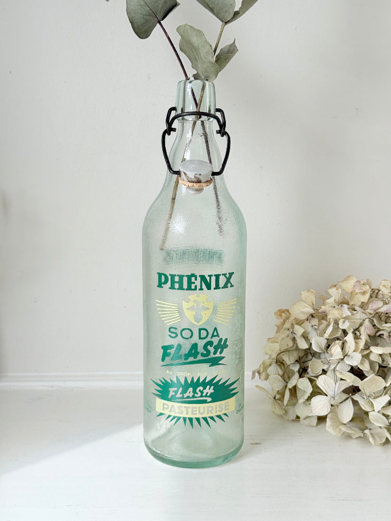 vintage french soda bottle phenix aqua green glass with ceramic swing top 31cm on white surface