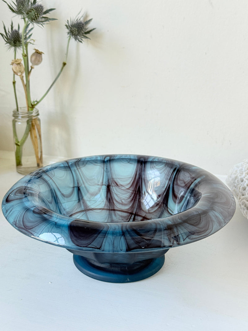 George Davidson blue cloud glass bowl with purple marbled swirls, photographed on a white surface