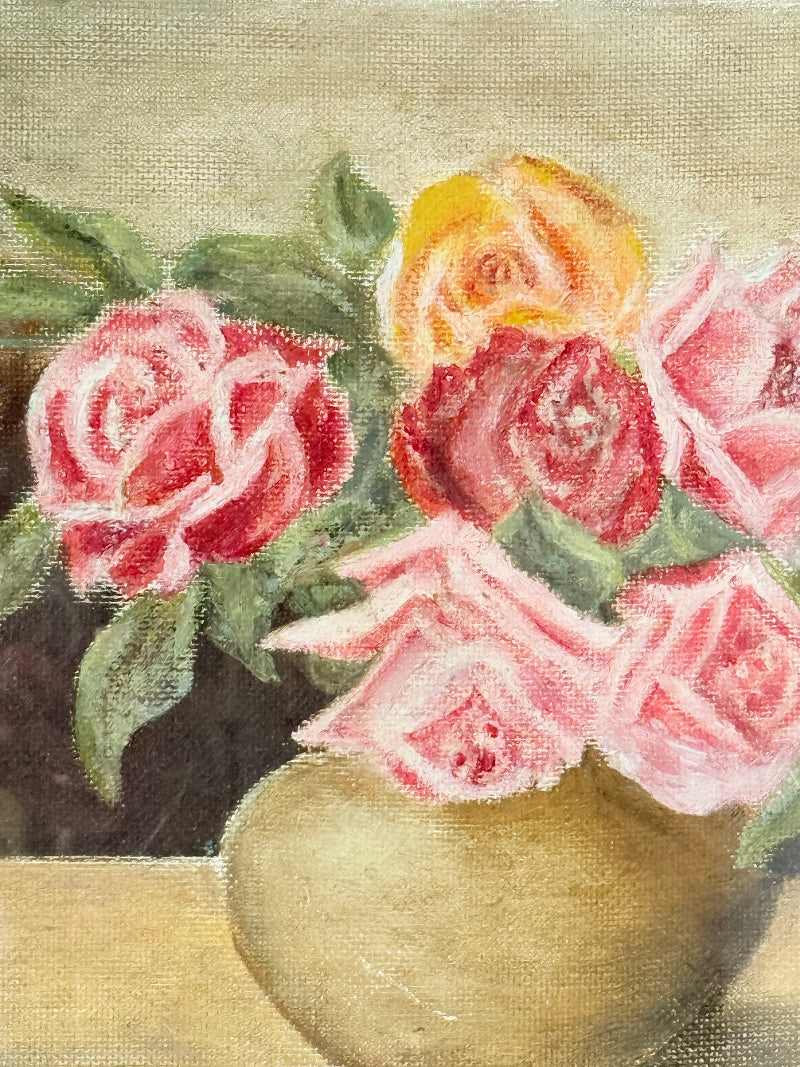 Framed original rose still life painting in pink and yellow, photographed on a white surface.