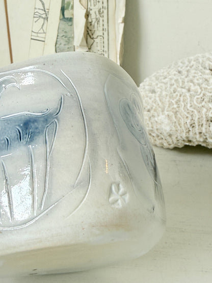 Hand painted ceramic pot with blue ram motif, pale grey off white glaze and handmade decorative form
