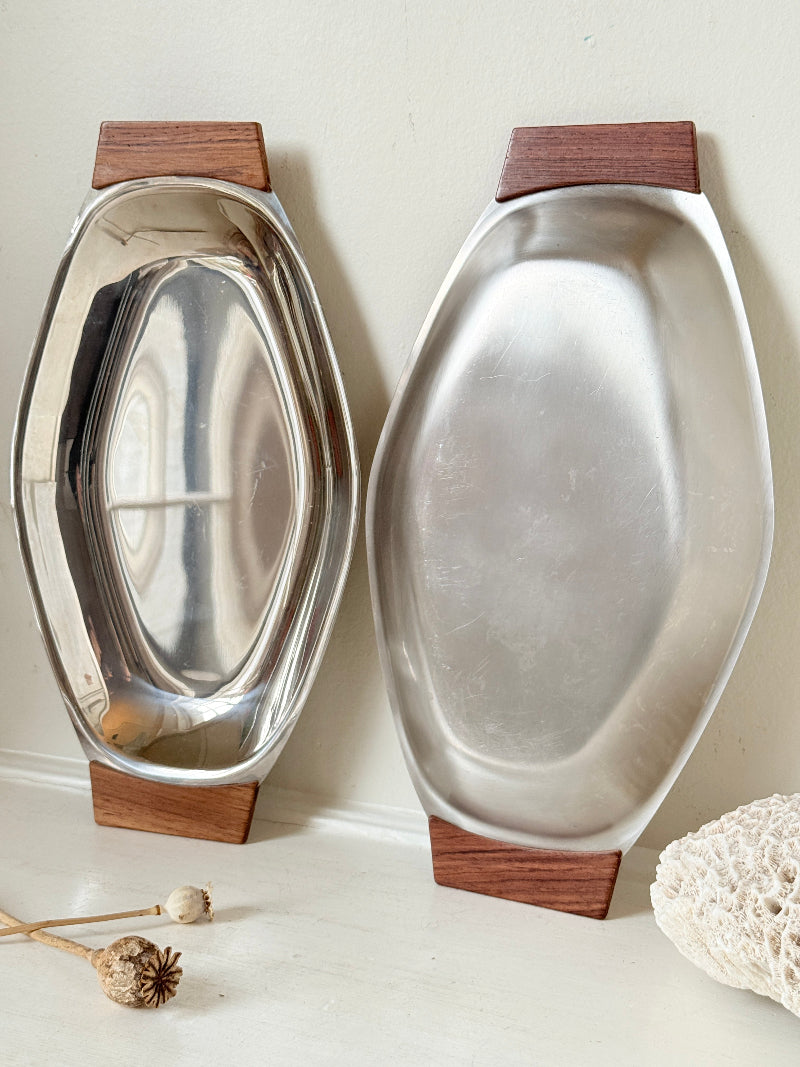 Pair of mid century stainless steel and teak crudites dishes photographed on a white surface