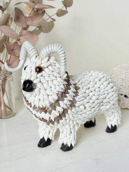 Vintage shell ram ornament in cream and brown, photographed on a white surface