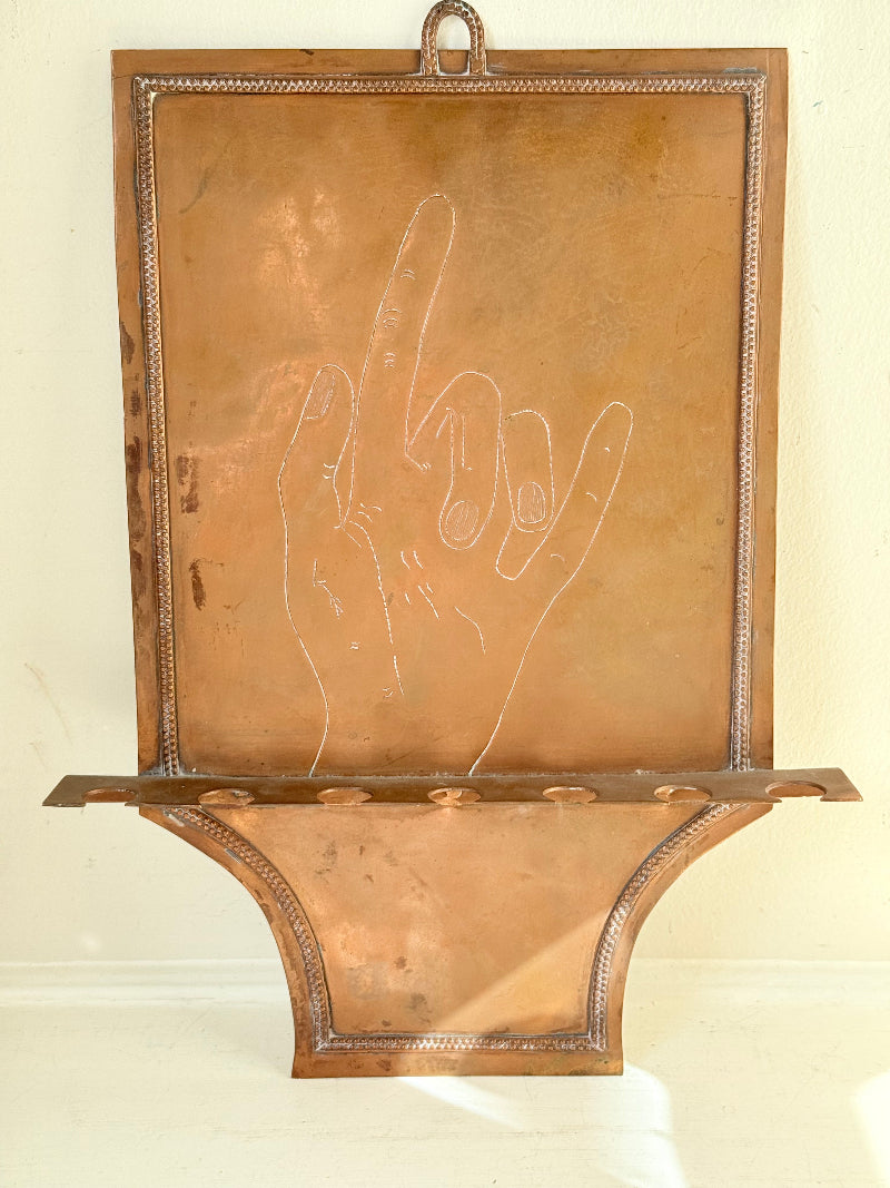 Vintage hanging copper pipe stand with hand etched design, ideal for holding utensils, tools or dog leads, photographed on a white surface beside dried stems.
