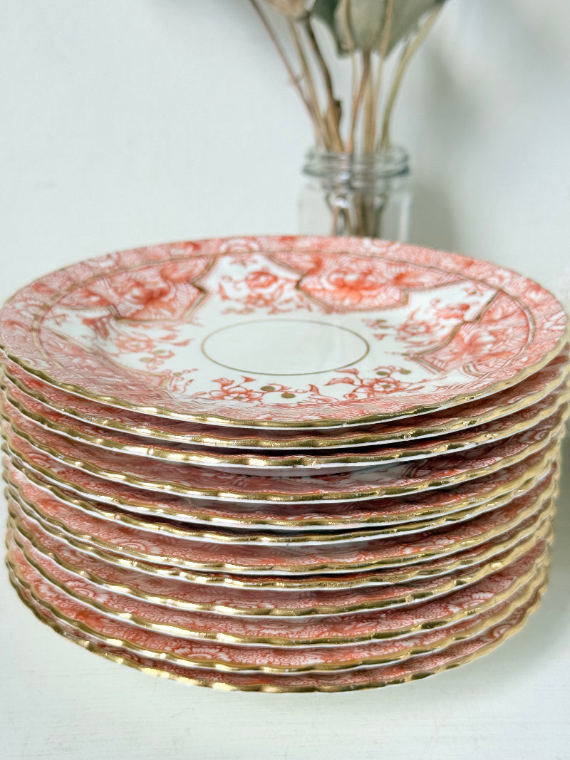 Set of 12 vintage coral transferware porcelain plates with scalloped edges and gold accents, 15 cm diameter, styled on a white surface.