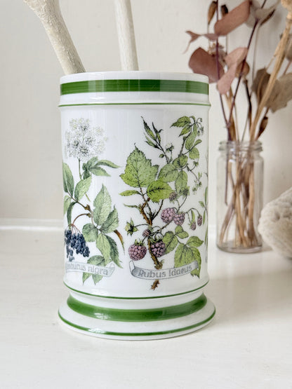 Vintage Kaiser W Germany porcelain utensil jar with botanical floral pattern and green rim photographed on a white surface