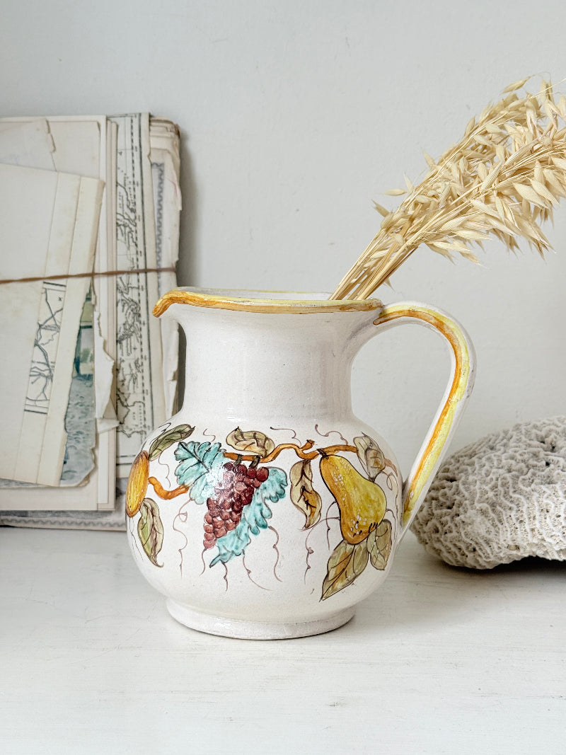 Vintage Deruta Italian hand painted maiolica jug with fruit and vine motif, yellow rim and Mediterranean ceramic styling