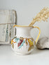 Vintage Deruta Italian hand painted maiolica jug with fruit and vine motif, yellow rim and Mediterranean ceramic styling