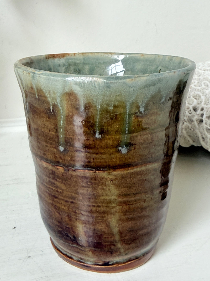 Pair of studio pottery mugs with complementary glazes photographed on a white surface