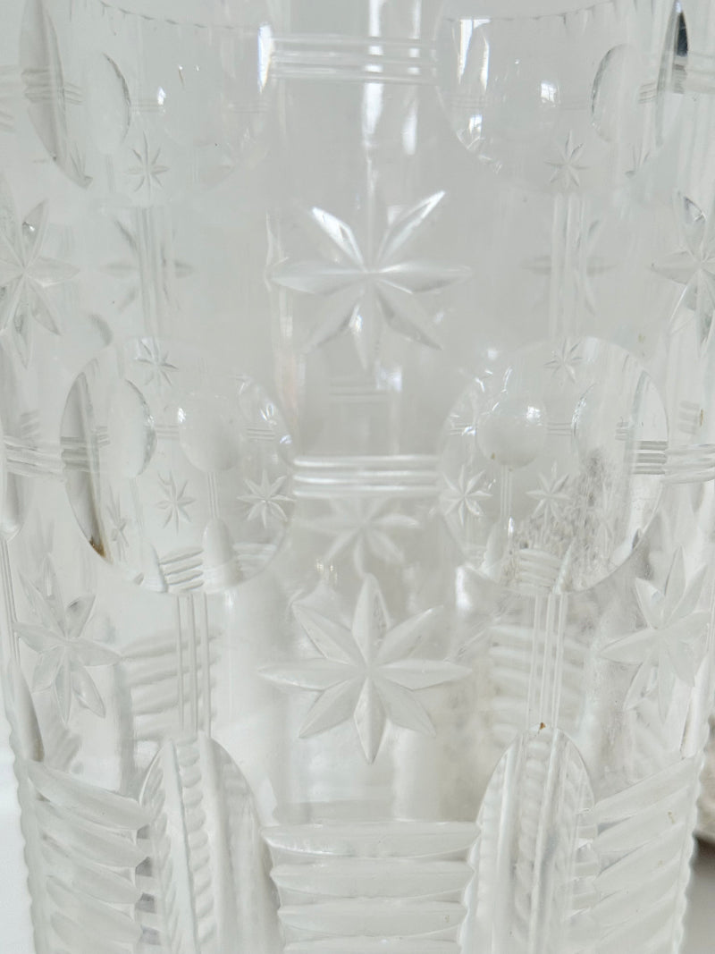 Vintage Stuart crystal cut glass vase with floral and star design, photographed on a white surface.