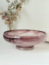 Vintage Davidson cloud glass bowl in mauve pink swirl photographed on a white surface