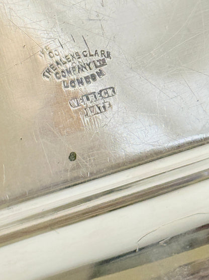Close-up of a silver-toned metal surface with engraved maker&