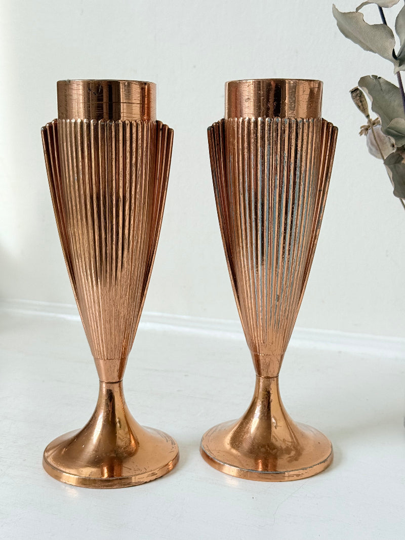 Pair of vintage copper Art Deco vases with fluted surface, photographed on a white background.