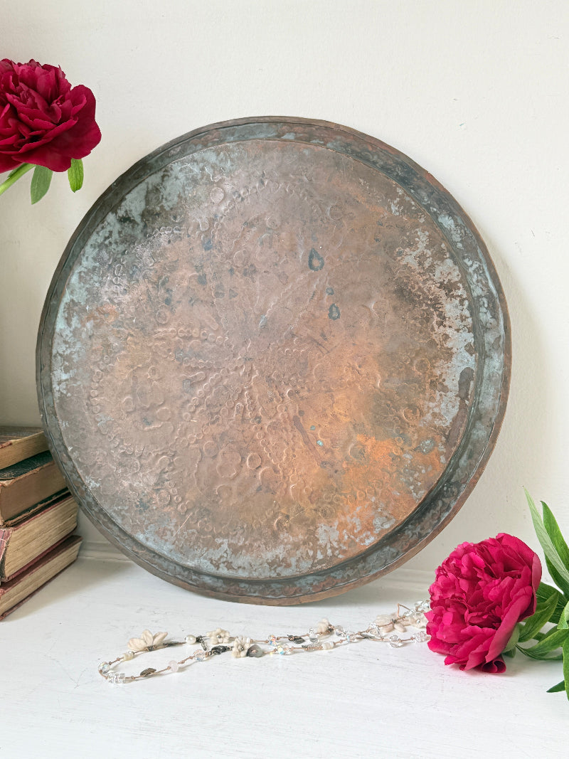 Vintage hand engraved copper tray with sunburst centre, decorative border and aged verdigris patina for wall or tabletop styling