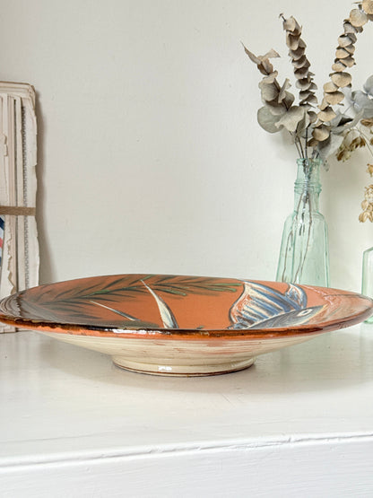Mid century Puigdemont La Bisbal charger with hand painted fish in blue and white on orange glaze