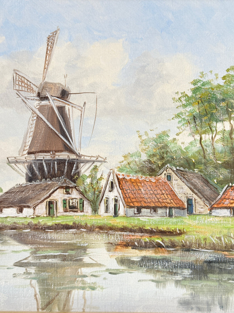Watercolor painting of a Dutch windmill and small houses beside a canal, with green trees and a pale blue sky.