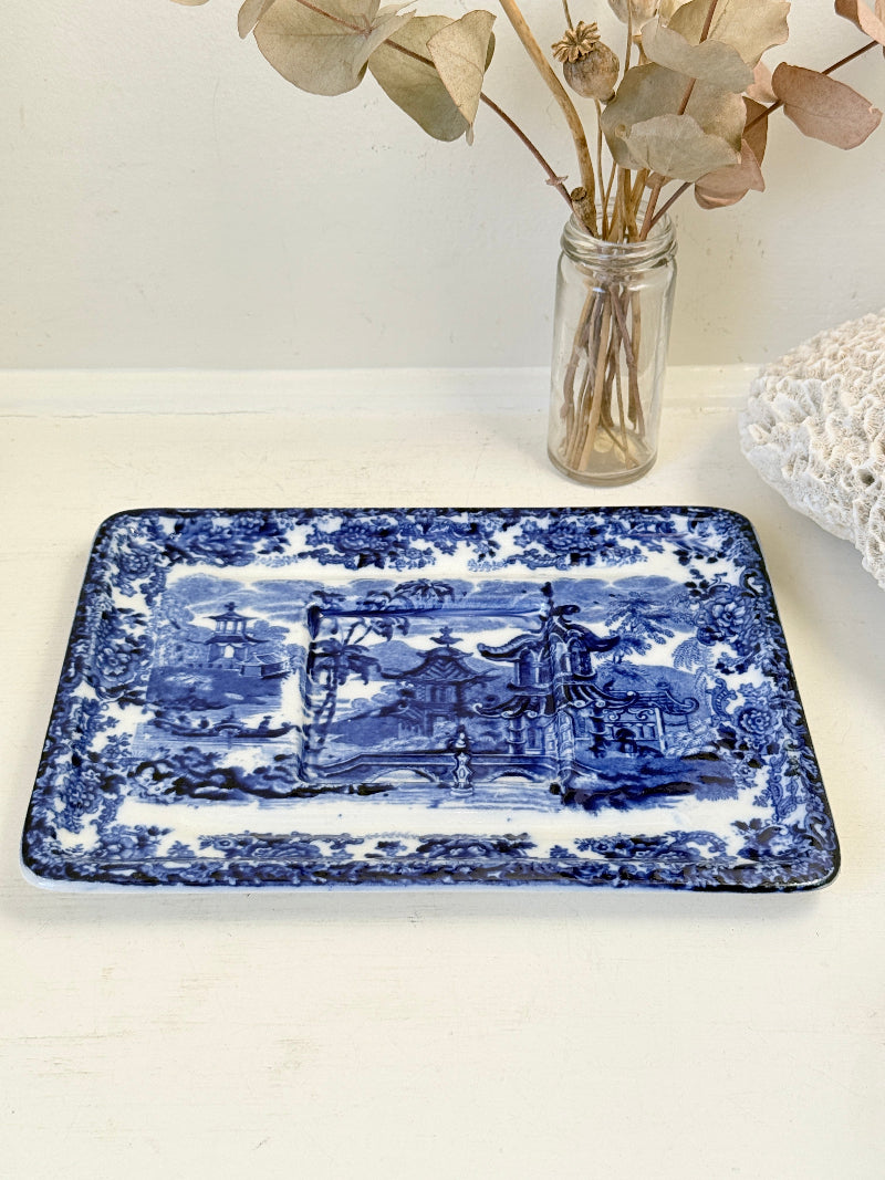 Vintage Wedgwood blue and white rectangular transferware plate with scenic design photographed on a white surface