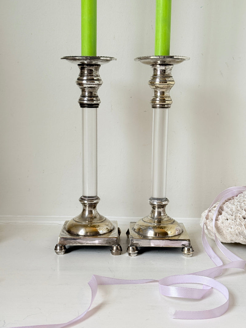 Pair of Hollywood Regency silver plate and Perspex Lucite candlesticks on bun feet with green taper candles