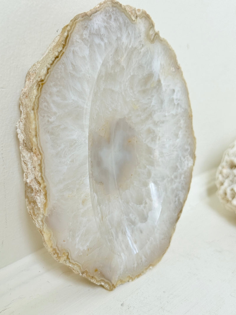 Vintage natural agate stone soap dish in grey and white, photographed on a white surface.
