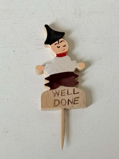 Vintage hand painted wooden steak markers on cocktail sticks labelled rare medium and well done, photographed on a white surface