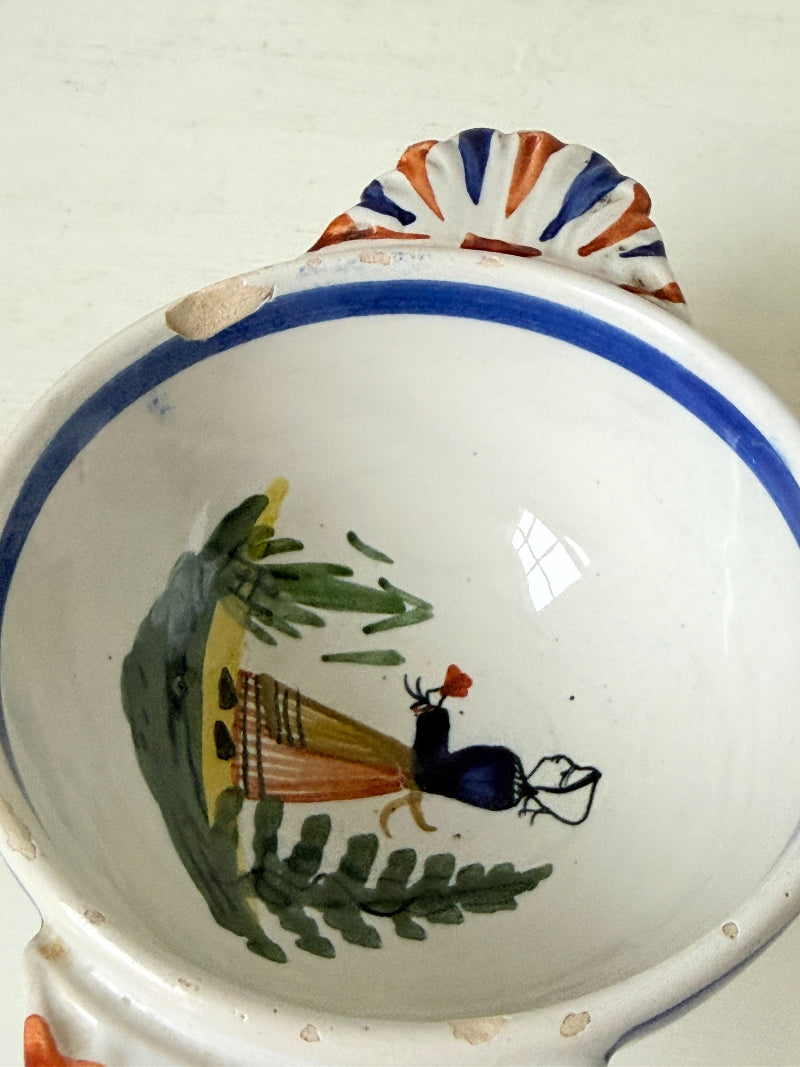 Pair of vintage French Quimper olive bowls with Breton figure and fan handles, photographed on a white surface