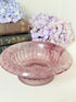 Davidson Cloud Glass bowl in amethyst with swirl pattern and footed base, styled with books and hydrangeas