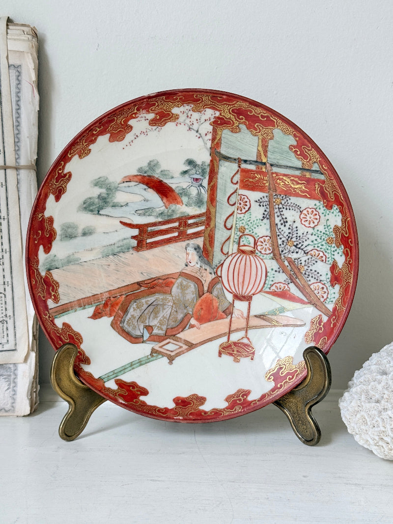 Japanese Kutani porcelain dish hand painted with a garden pavilion scene in iron red and gold