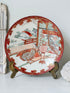Japanese Kutani porcelain dish hand painted with a garden pavilion scene in iron red and gold