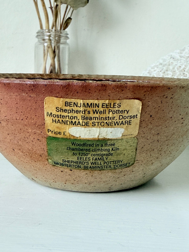 Benjamin Eeles studio pottery stoneware bowl with green and blue glazed interior on a white surface.