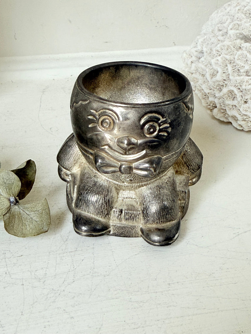 Vintage Humpty Dumpty silver plate egg cup, photographed on a white surface