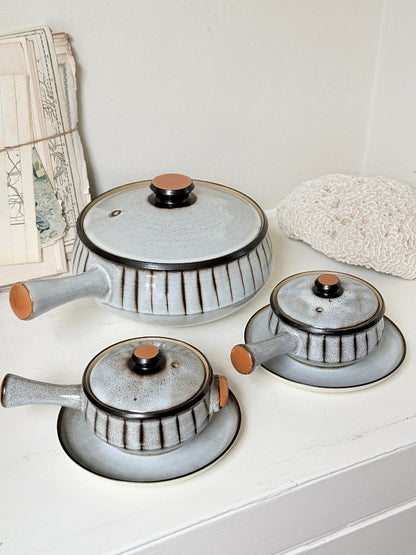 Denby Studio stoneware casserole and soup bowl set in grey and rust photographed on a white surface