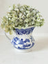 Vintage Churchill Blue Willow milk jug in blue and white ceramic photographed on a white surface.
