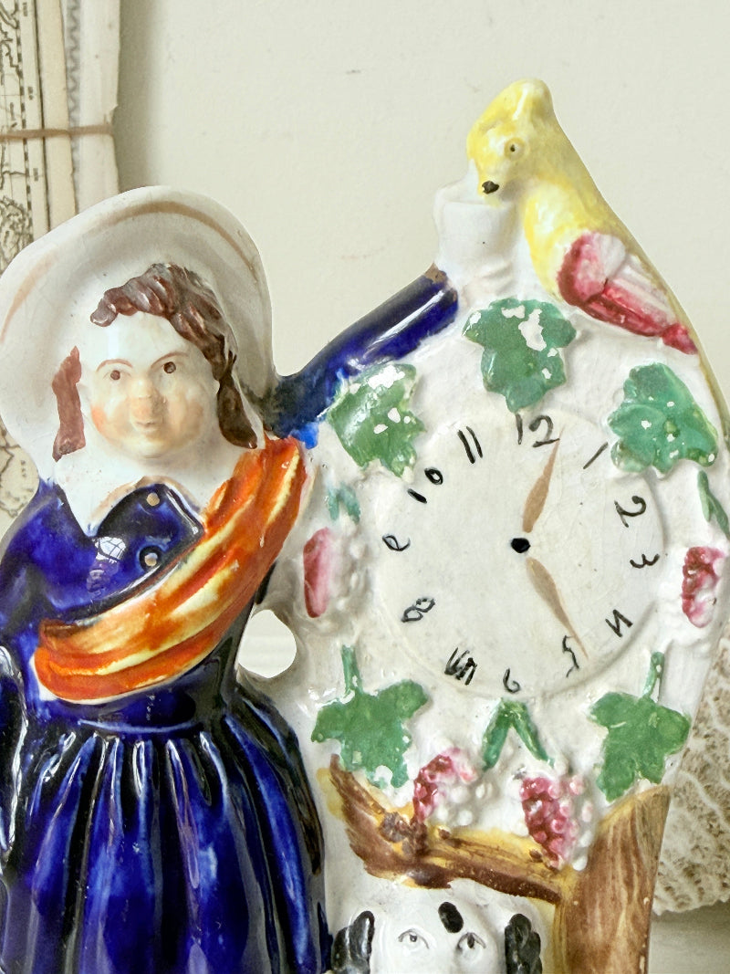 Victorian Staffordshire flatback clock group with girl spaniel and parrot hand painted in cobalt blue and orange