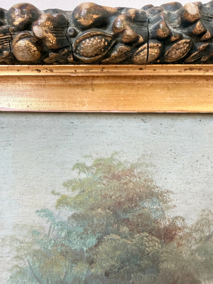 Close-up of an antique framed painting showing a textured gold and dark brown carved frame above a muted landscape painting with trees.